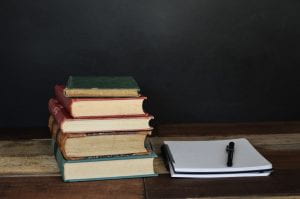 stack of books with a notebook Photo by Debby Hudson on Unsplash