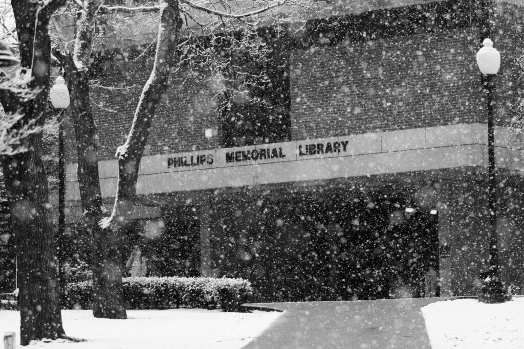 Black and white image of snow falling in front of the Library.