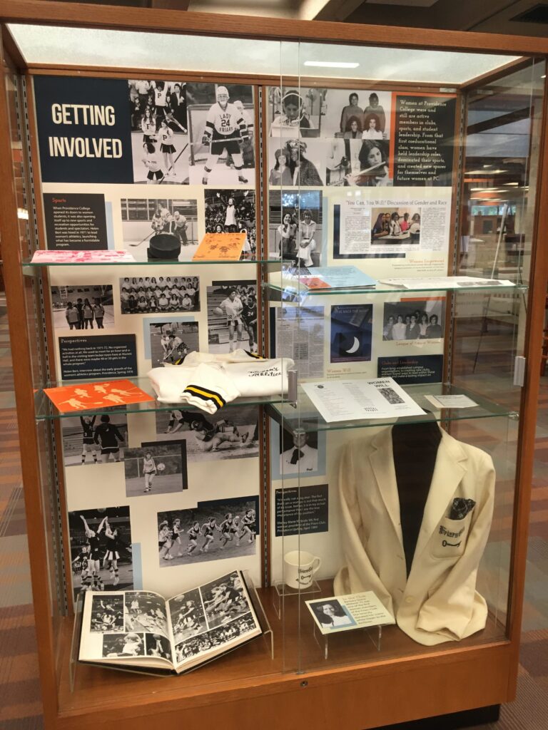An exhibit displaying materials from the archives about the first women who attended Providence College.