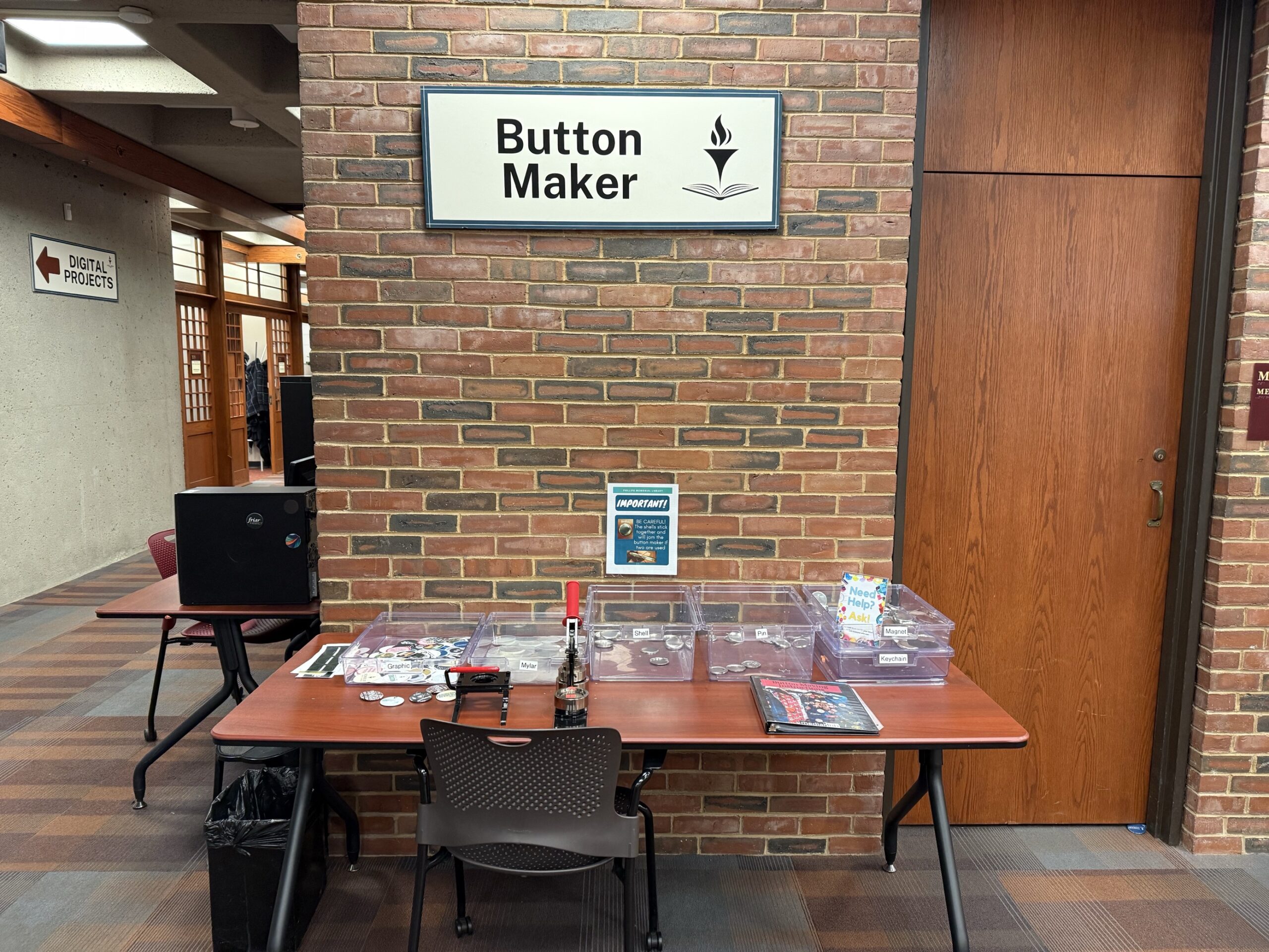 Image of button maker table in Phillips Memorial Library