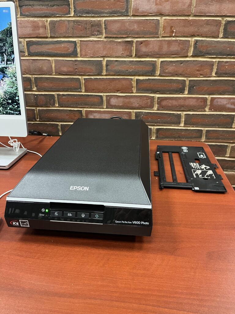 Flatbed Scanner with film scanning inserts next to it on table