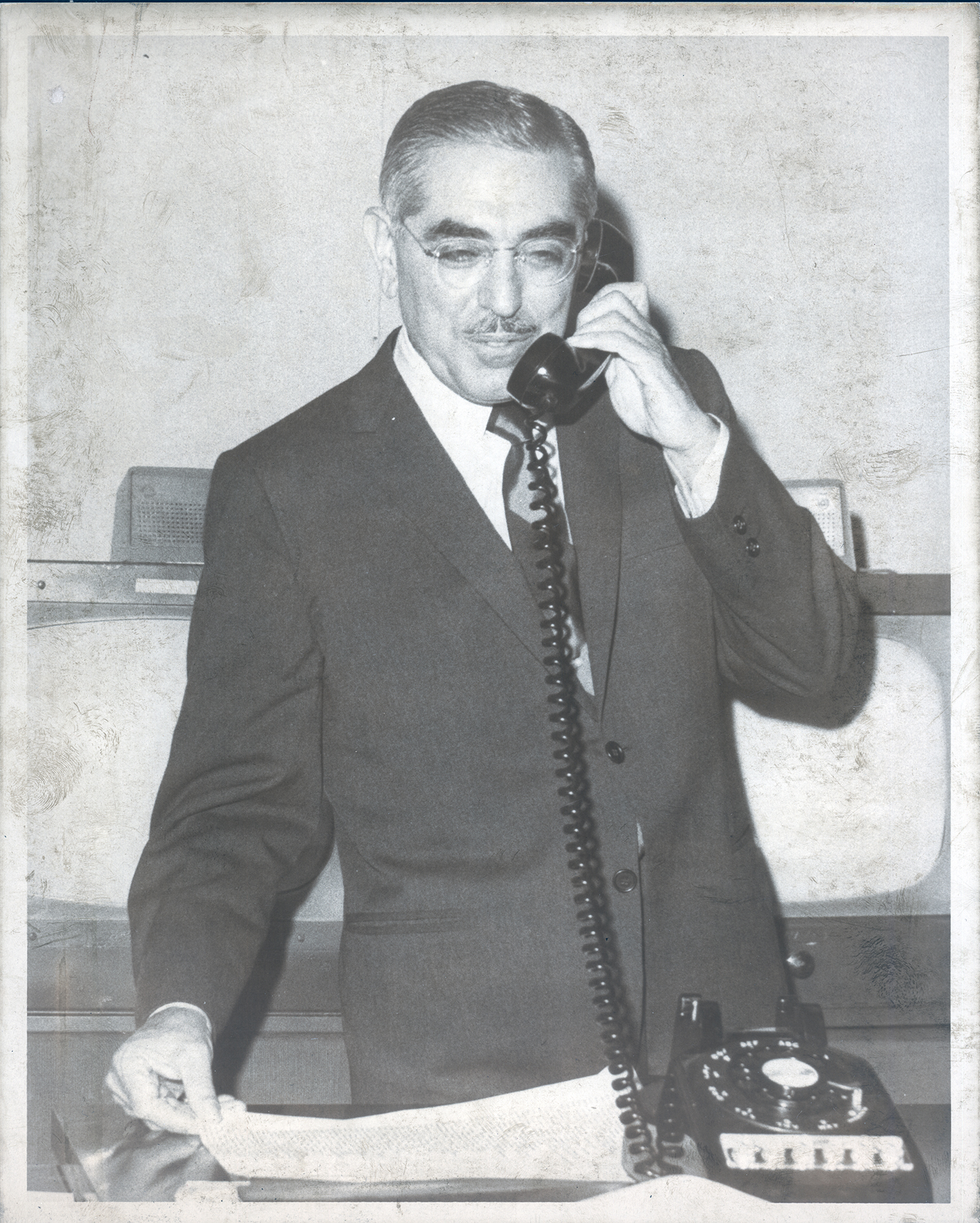 Senator John O. Pastore sits at a desk in Washington, D.C.