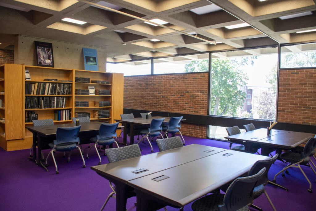 Fogarty Reading Room with study tables, bookshelves, and large windows.