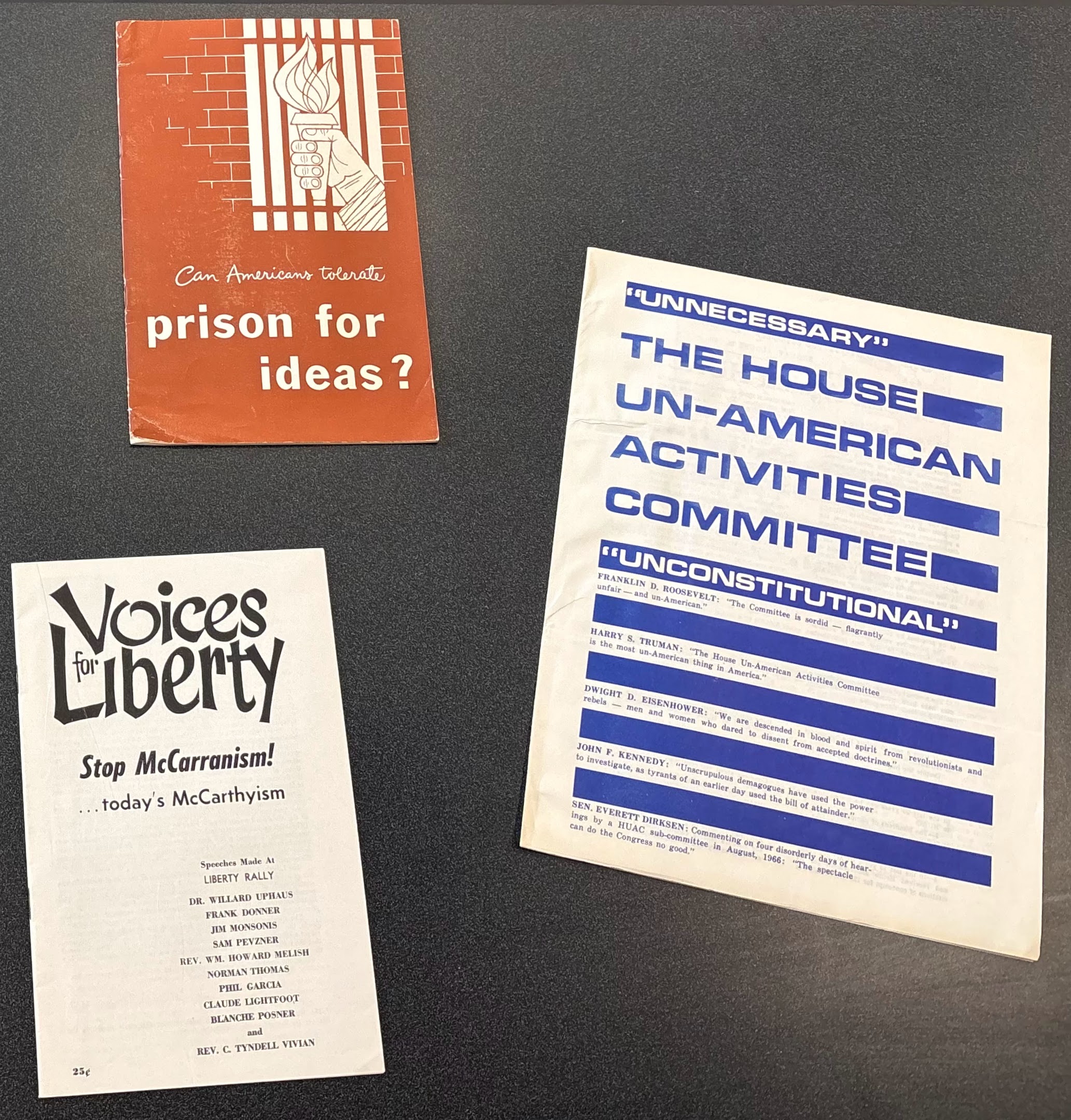 image of three pamphlets laying on a tabletop. Pamphlet subjects cover communist activities in the United States